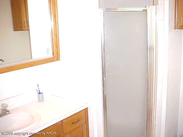 8407 Lamount Drive Amarillo, TX 79110 - Photo 12 of 12 a bathroom with a bathtub and a sink