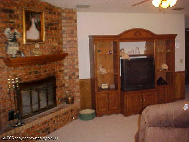 8407 Lamount Drive Amarillo, TX 79110 - Photo 6 of 12 a living room with furniture and a fireplace