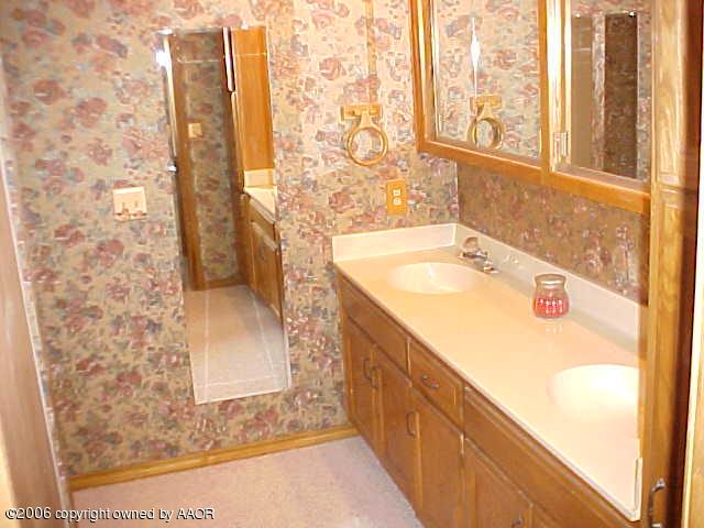 8407 Lamount Drive Amarillo, TX 79110 - Photo 9 of 12 a bathroom with a granite countertop sink and a shower