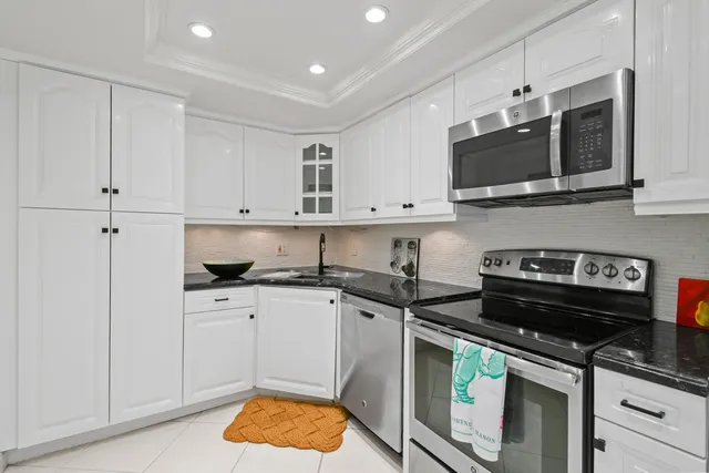 a kitchen with stainless steel appliances granite countertop a stove a microwave and cabinets