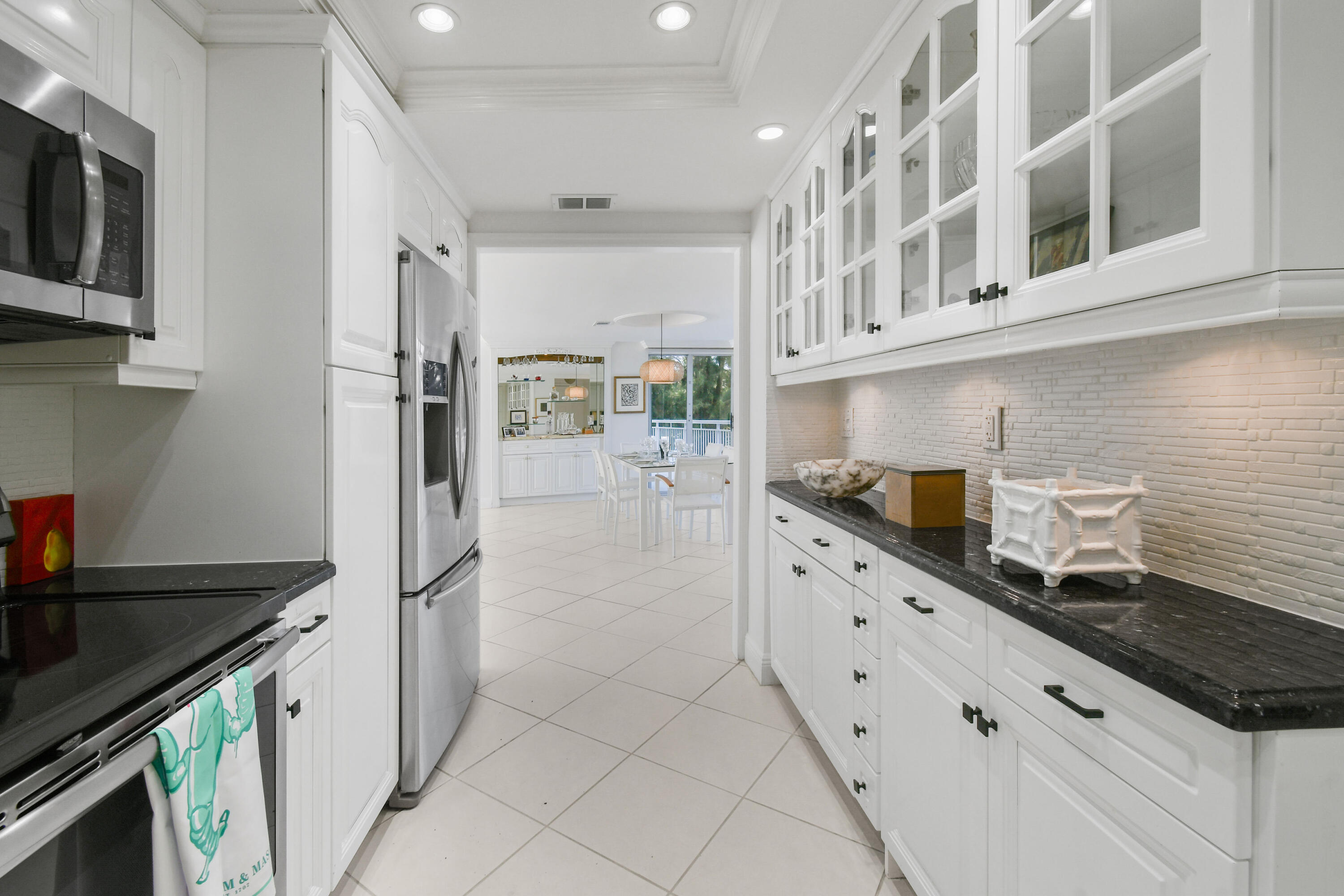 2780 South Ocean Boulevard, Unit 112 Palm Beach, FL 33480 - Photo 12 of 55 a kitchen with stainless steel appliances a sink stove and refrigerator