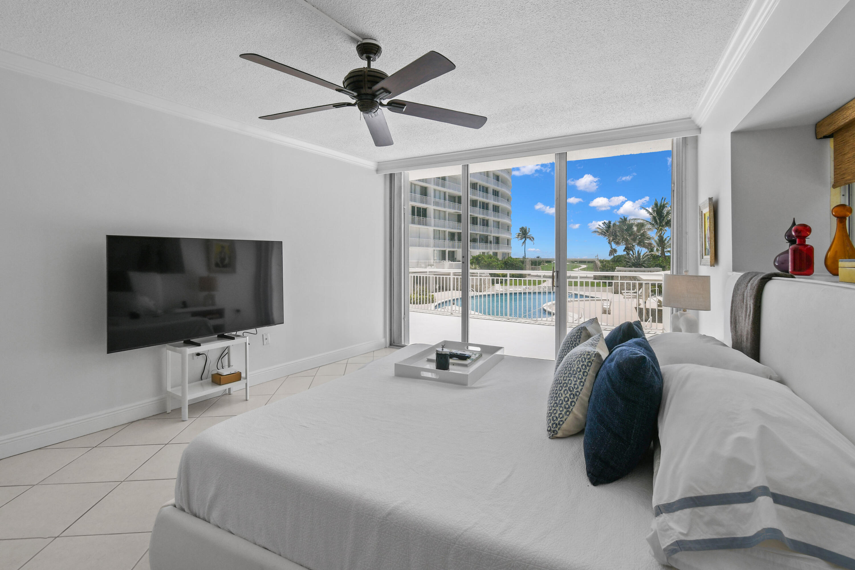 2780 South Ocean Boulevard, Unit 112 Palm Beach, FL 33480 - Photo 13 of 55 a view of a livingroom with furniture window and a flat screen tv