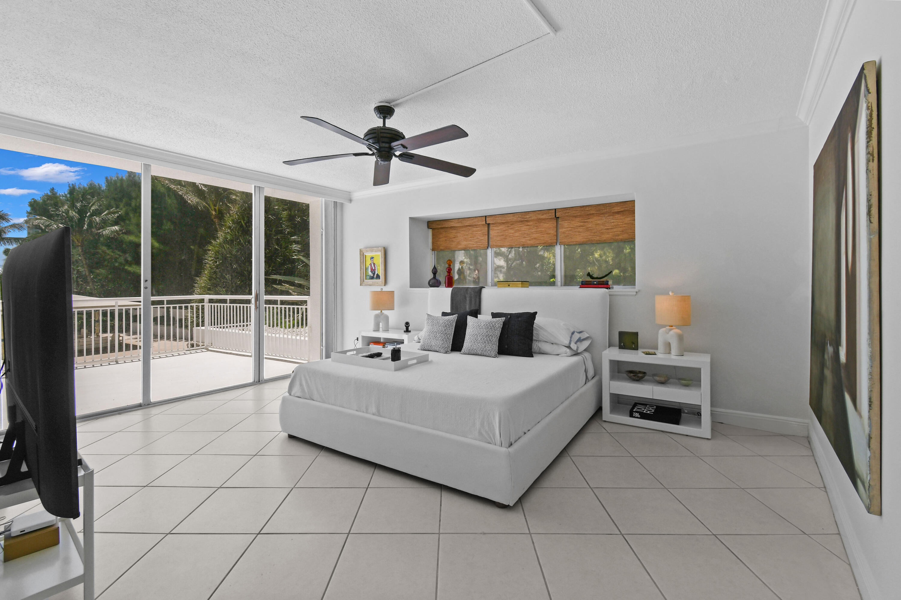 2780 South Ocean Boulevard, Unit 112 Palm Beach, FL 33480 - Photo 15 of 55 a bed room with a bed and a large window