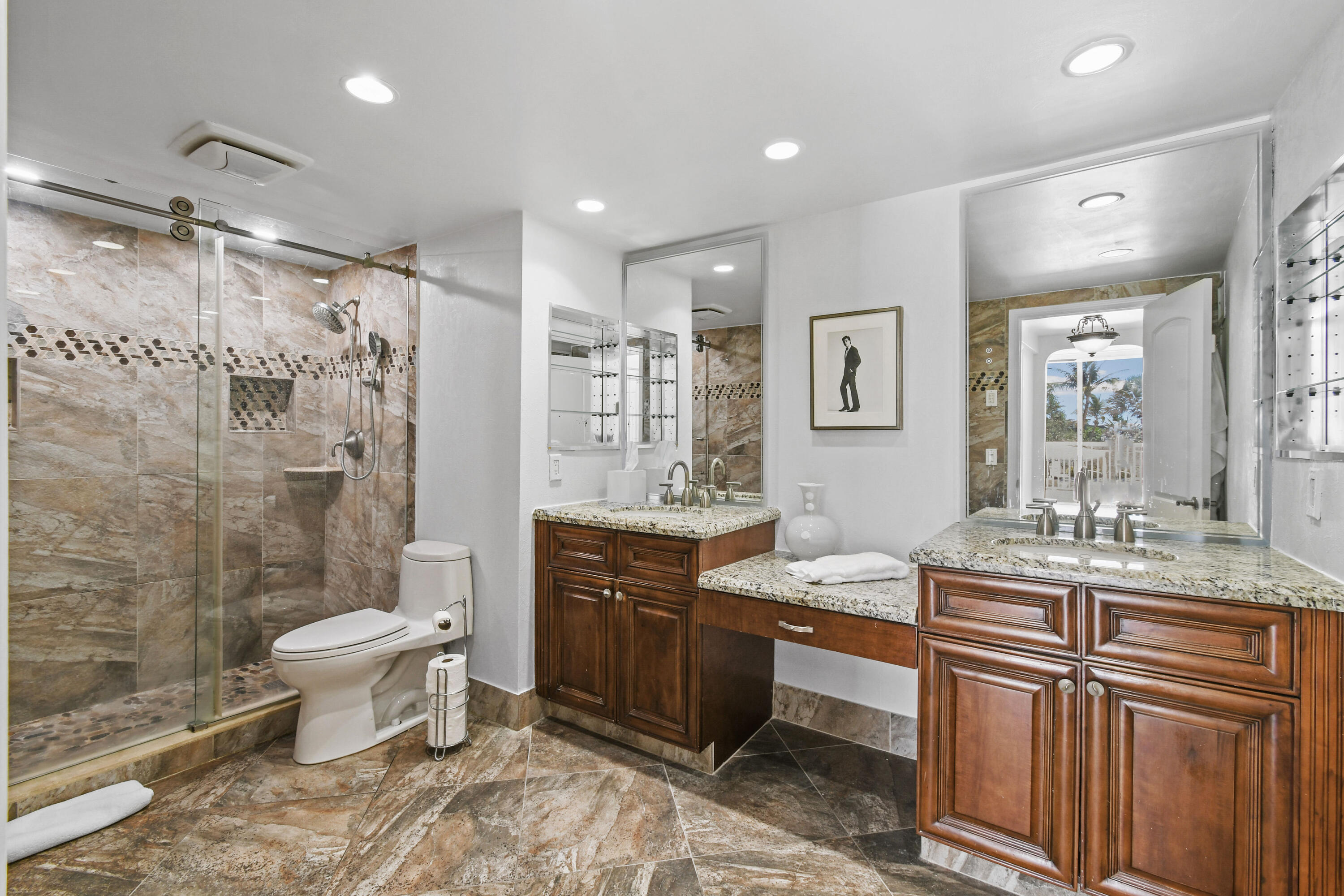 2780 South Ocean Boulevard, Unit 112 Palm Beach, FL 33480 - Photo 17 of 55 a bathroom with a granite countertop sink toilet mirror and shower