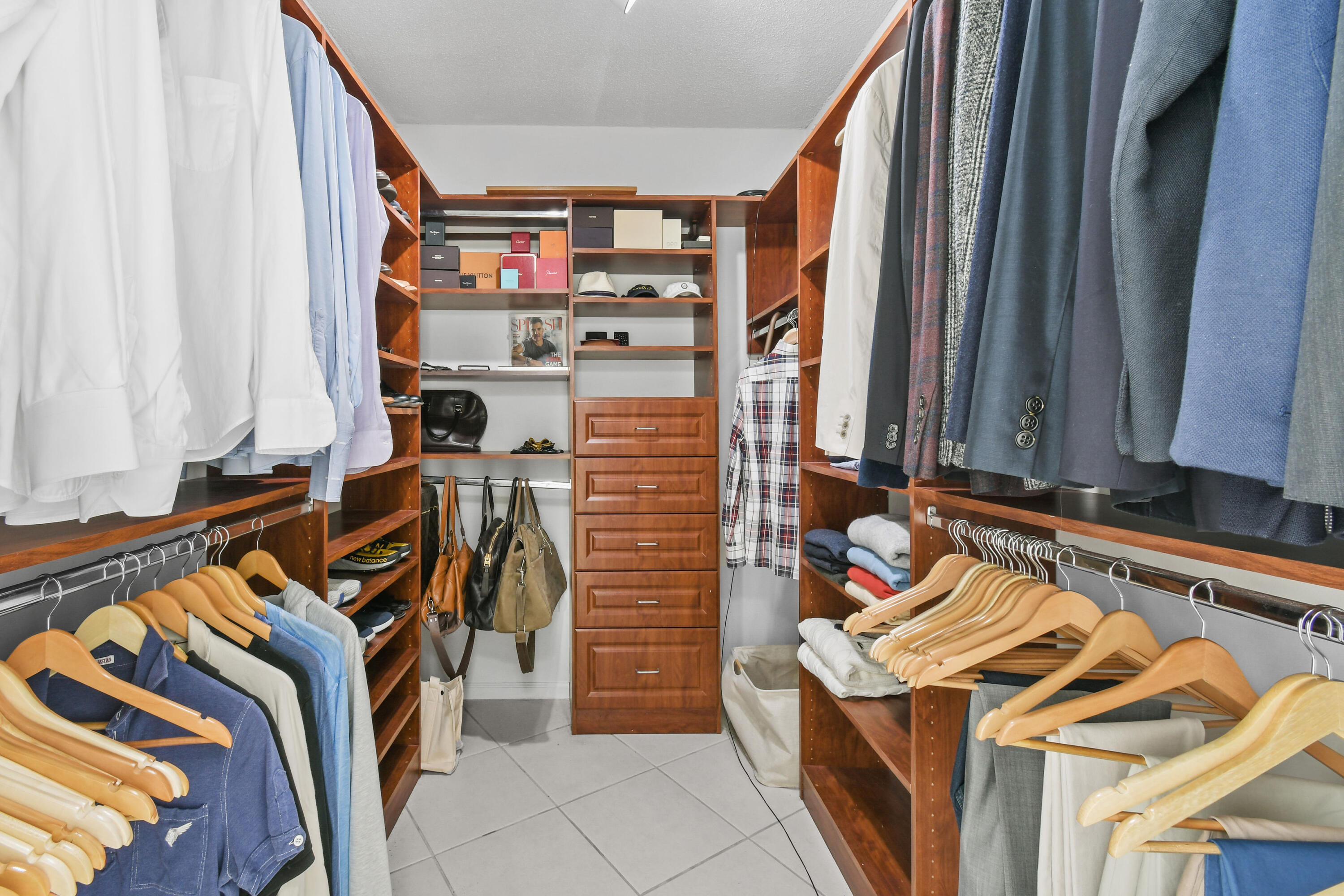 2780 South Ocean Boulevard, Unit 112 Palm Beach, FL 33480 - Photo 19 of 55 a view of walk in closet with clothes and shoes