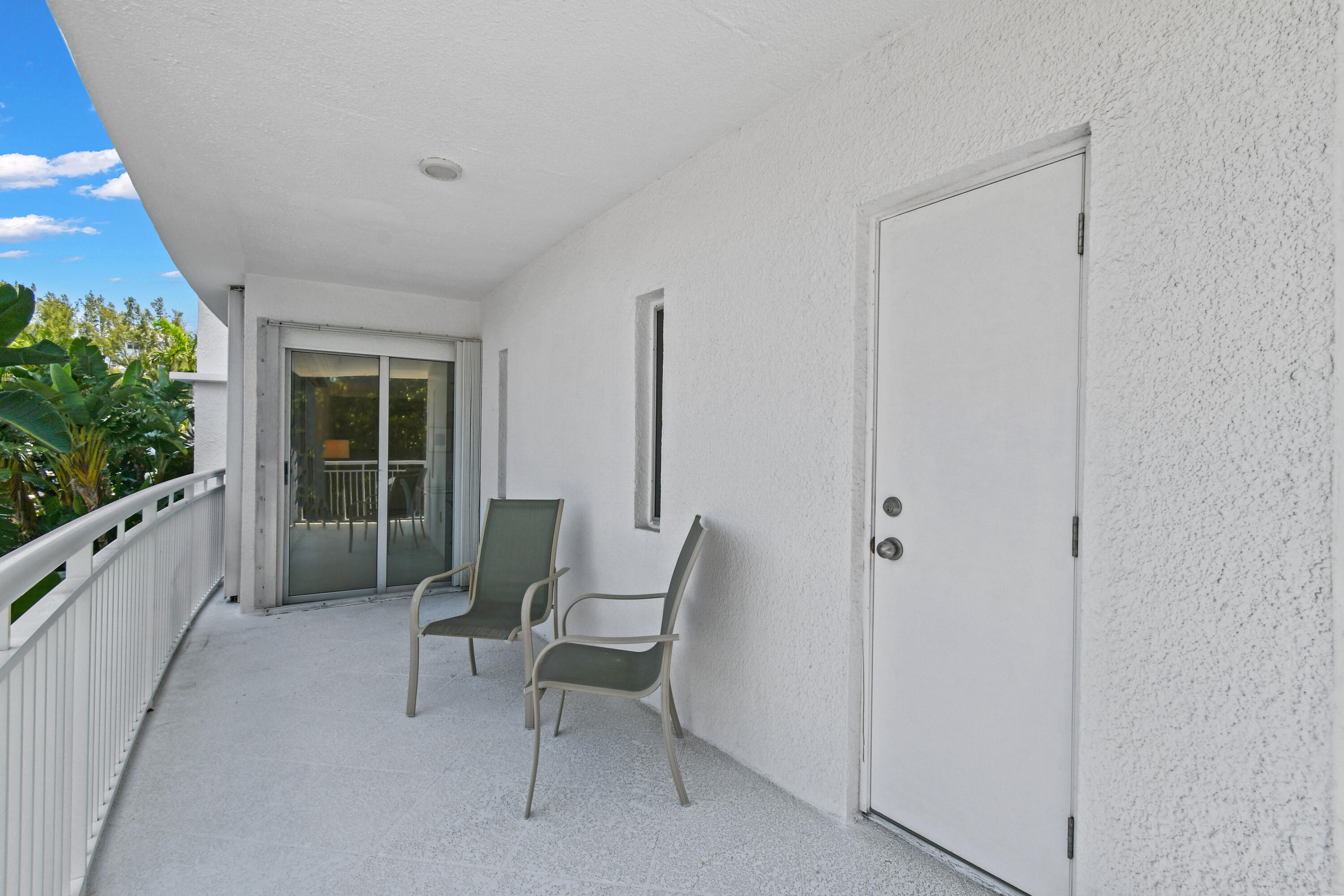 2780 South Ocean Boulevard, Unit 112 Palm Beach, FL 33480 - Photo 24 of 55 a balcony with chairs and a table