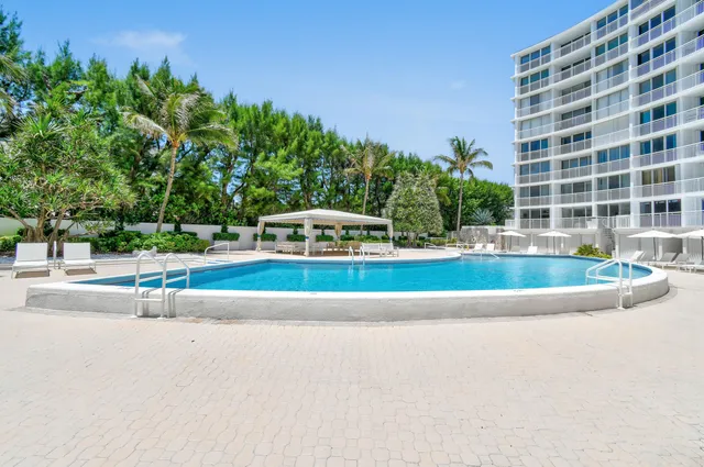 a view of a patio with a table and chairs and potted plants