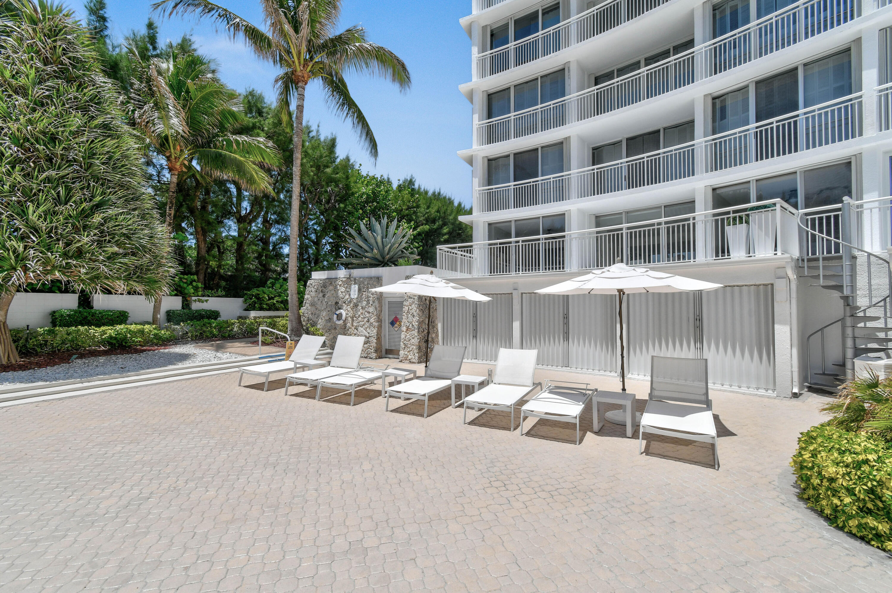 2780 South Ocean Boulevard, Unit 112 Palm Beach, FL 33480 - Photo 32 of 55 a view of a patio with a table and chairs and potted plants