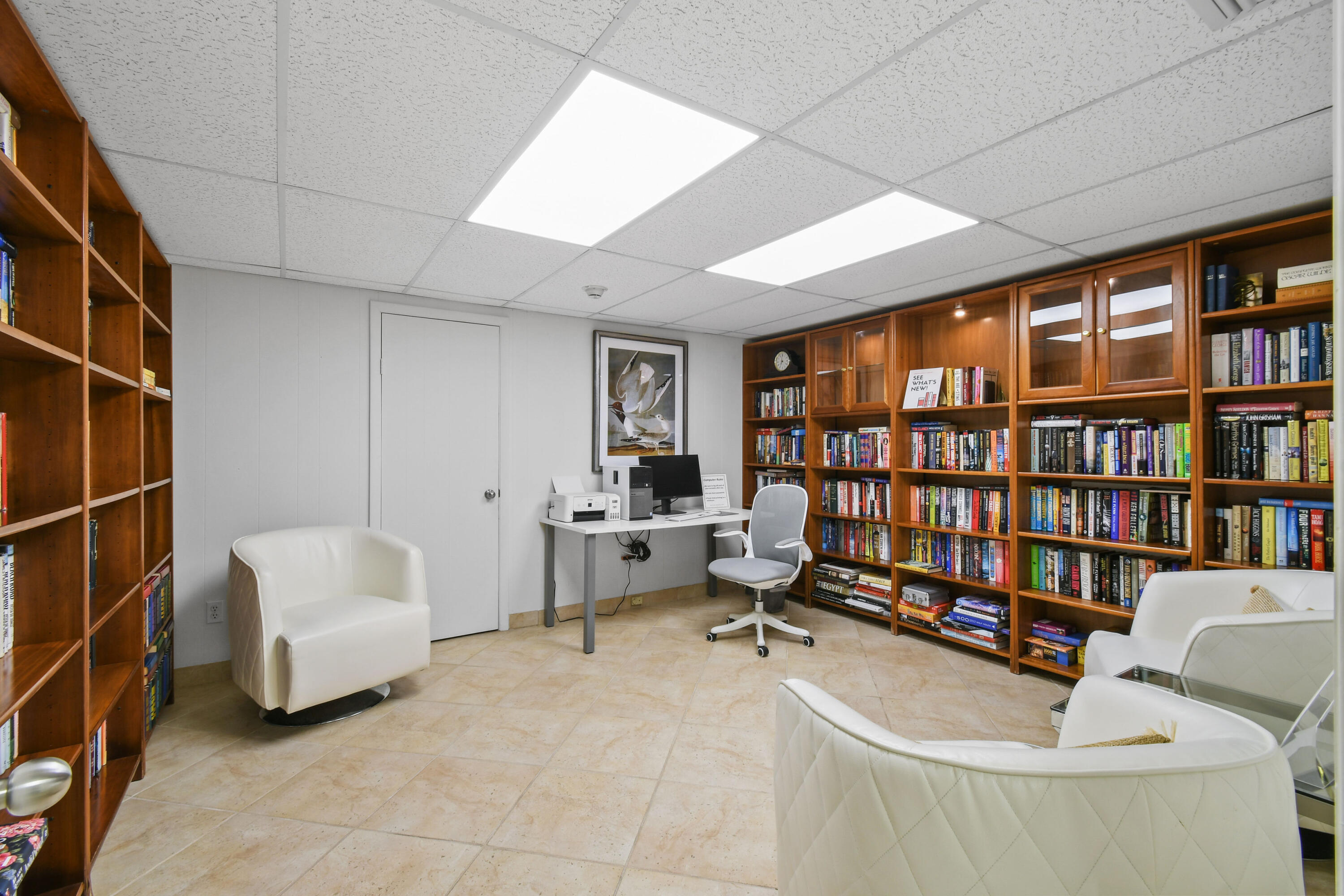 2780 South Ocean Boulevard, Unit 112 Palm Beach, FL 33480 - Photo 45 of 55 a living room with furniture a rug and a book shelf