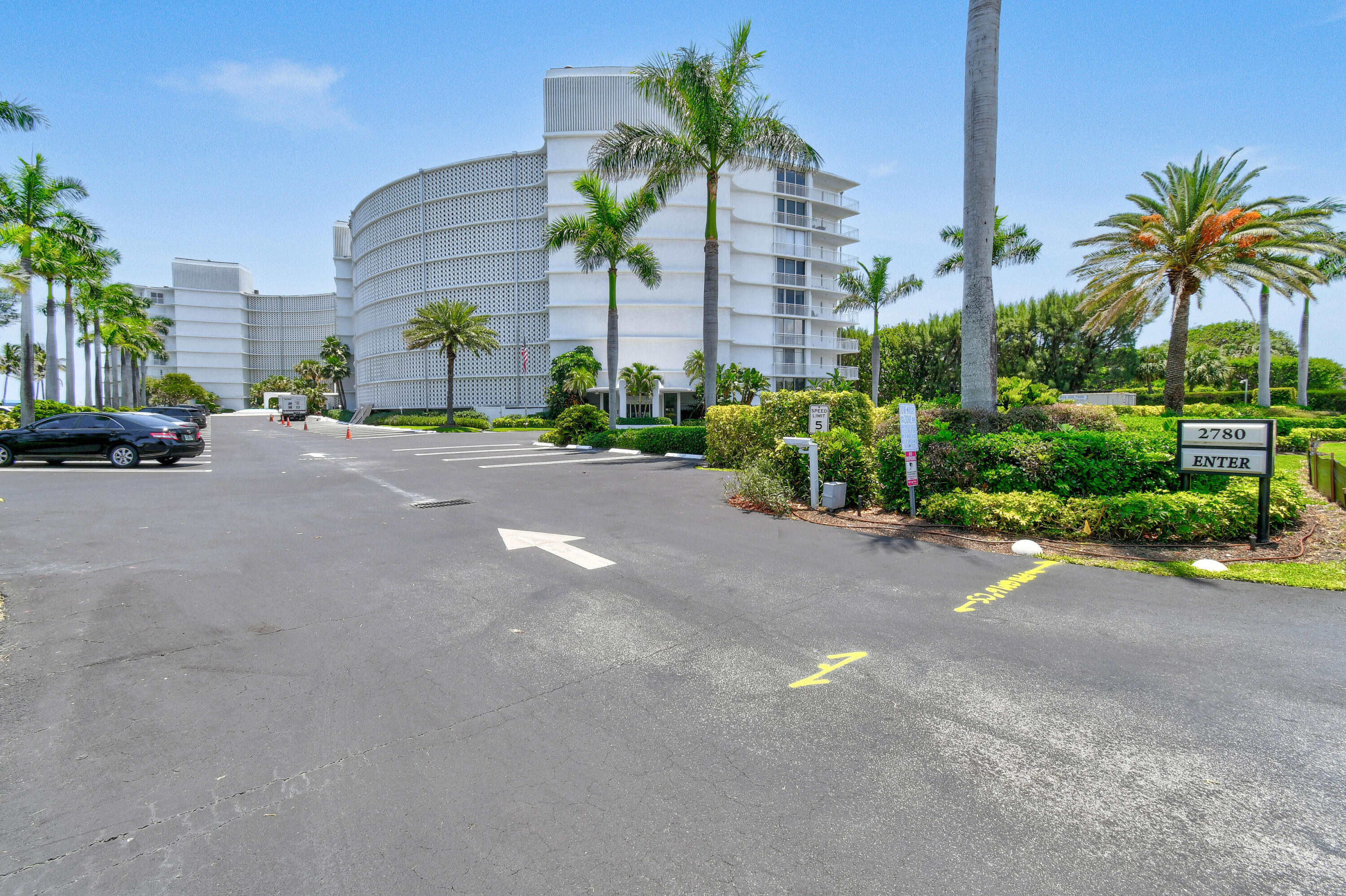 2780 South Ocean Boulevard, Unit 112 Palm Beach, FL 33480 - Photo 54 of 55 a view of a street with a building and palm trees