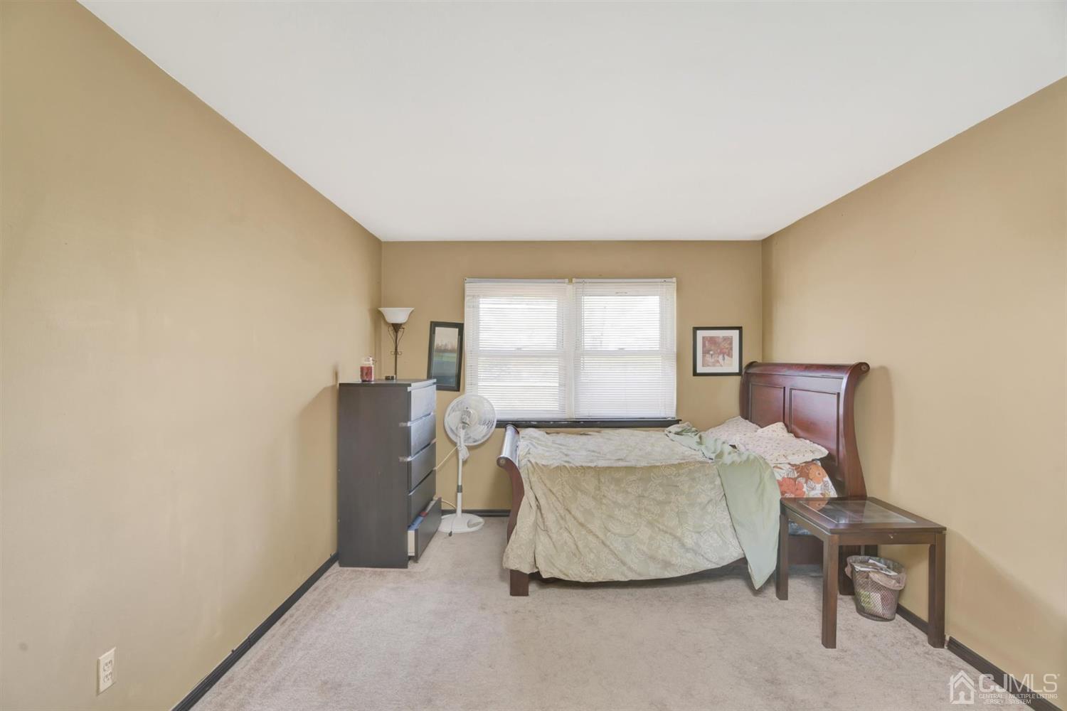 199 Evergreen Road, Unit 4B Edison, NJ 08837 - Photo 11 of 28 a living room with furniture and a window