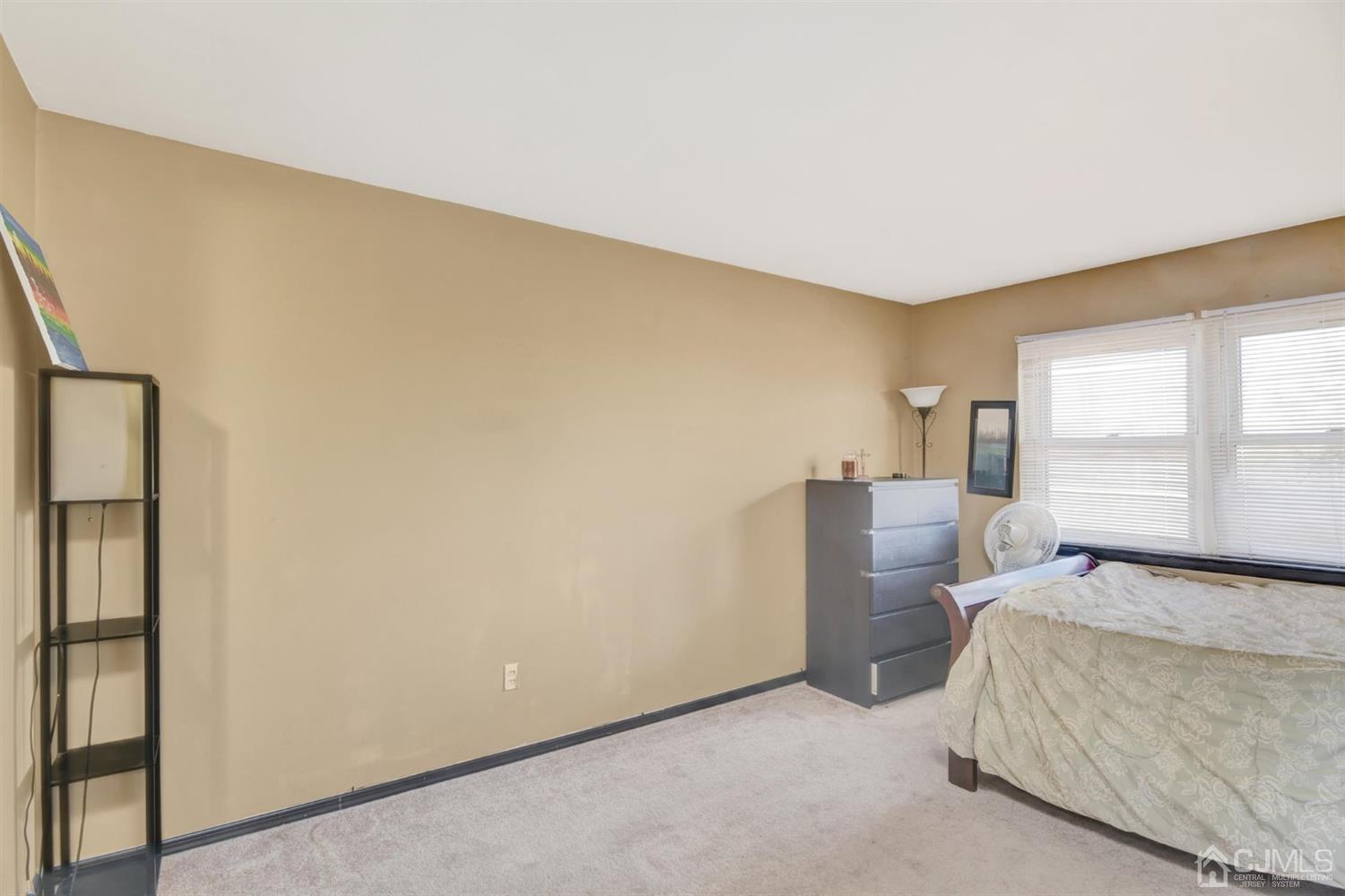 199 Evergreen Road, Unit 4B Edison, NJ 08837 - Photo 13 of 28 a bedroom with a bed and a window