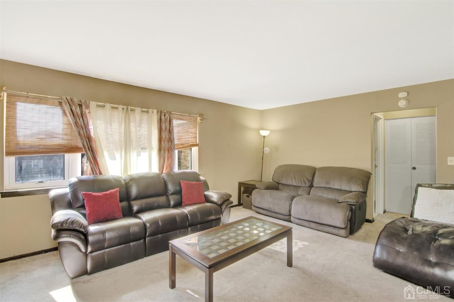 199 Evergreen Road, Unit 4B Edison, NJ 08837 - Photo 5 of 28 a living room with furniture and a large window