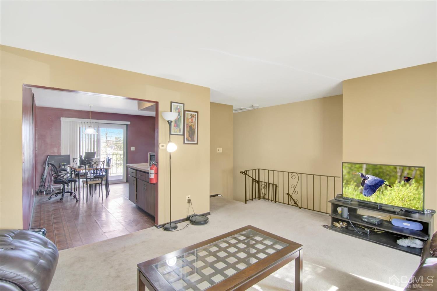 199 Evergreen Road, Unit 4B Edison, NJ 08837 - Photo 8 of 28 a living room with furniture and a flat screen tv