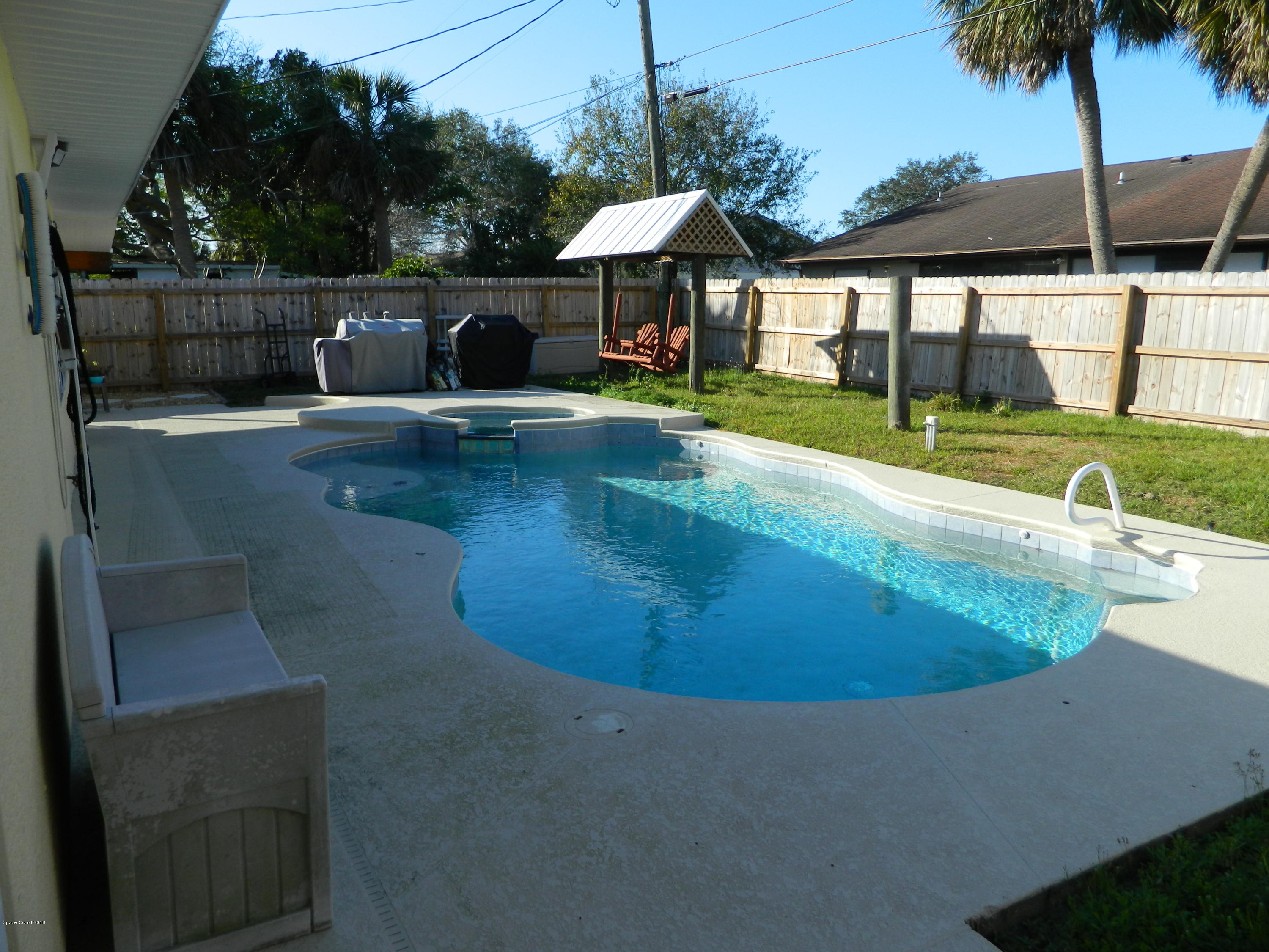1778 Palm Ridge Road Melbourne, FL 32935 - Photo 16 of 19 Heated Pool with covered yard swing