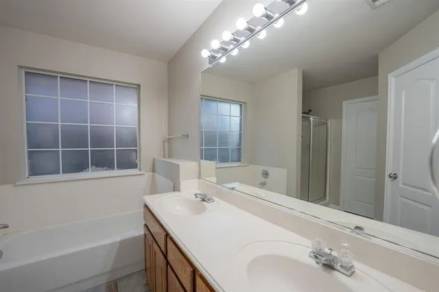 a bathroom with a tub sink and a mirror