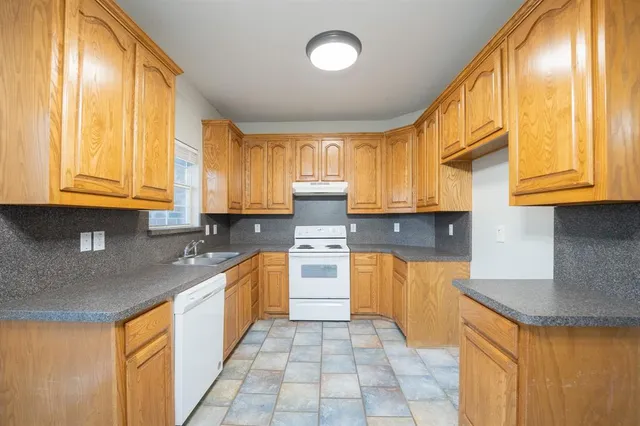 a kitchen with stainless steel appliances granite countertop a sink and cabinets