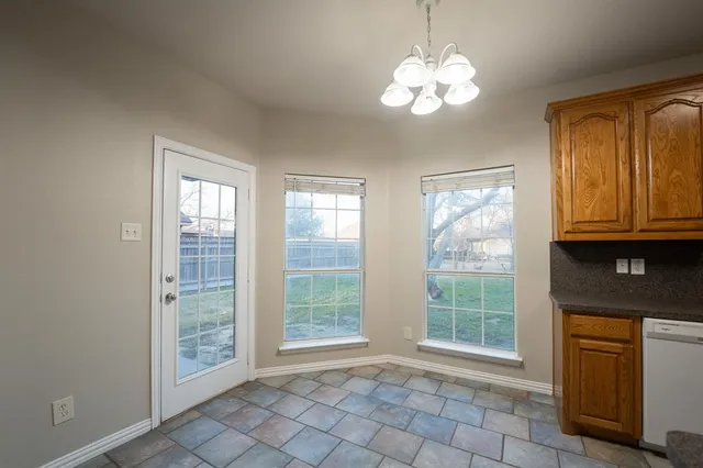 an empty room with windows and cabinet