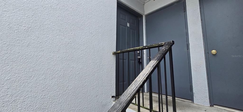 3321 Southwest 34th Ave Circle, Unit 5 Ocala, FL 34474 - Photo 2 of 10 a view of staircase with wooden floor and white walls