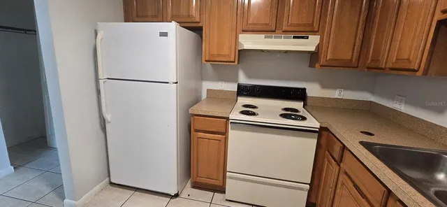 a kitchen with a refrigerator a stove a washer and dryer