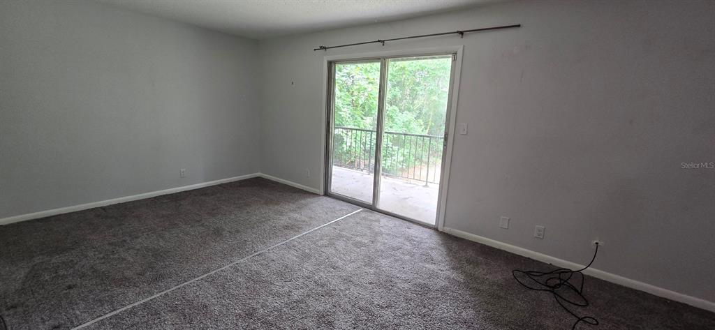 3321 Southwest 34th Ave Circle, Unit 5 Ocala, FL 34474 - Photo 6 of 10 an empty room with a empty space and a window