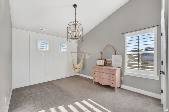 14714 South Bright Wood Road Herriman, UT 84096 - Photo 25 of 41 Carpeted bedroom 1 featuring vaulted ceiling, a chandelier, Hammock chair and a decorative wall