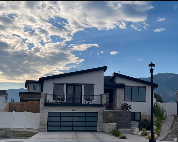 655 Oliver Road Tooele, UT 84074 - Photo 2 of 21 Contemporary residence featuring a white stucco exterior with stone accents