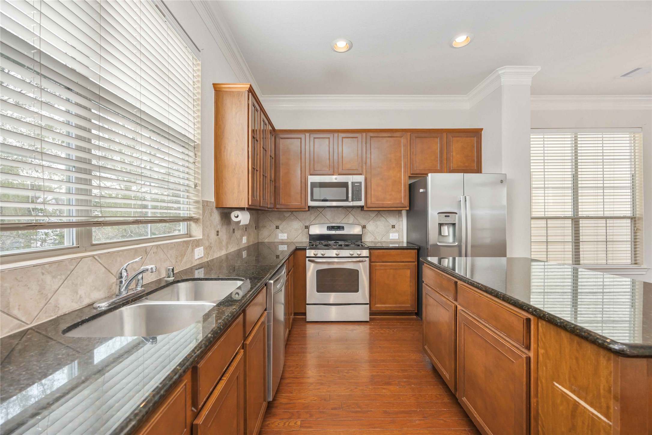 3008 Clearview Circle Houston, TX 77025 - Photo 12 of 33 a kitchen with stainless steel appliances granite countertop a sink a stove top oven a counter space and cabinets