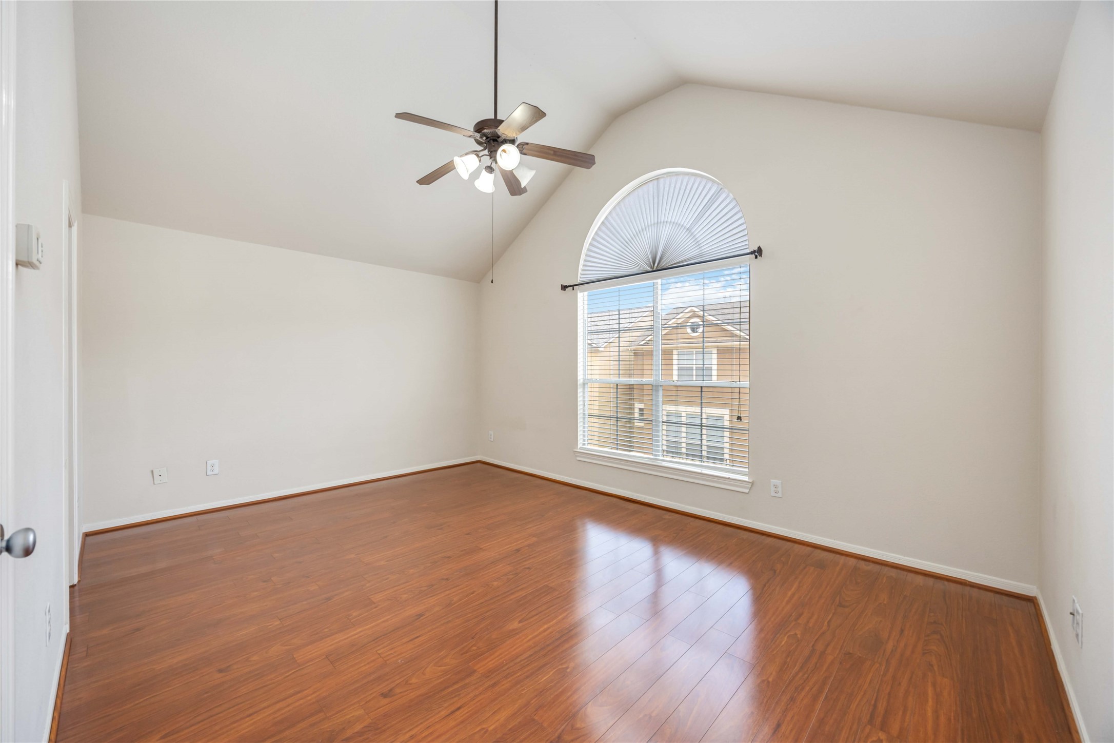 3008 Clearview Circle Houston, TX 77025 - Photo 15 of 33 an empty room with wooden floor chandelier fan and windows