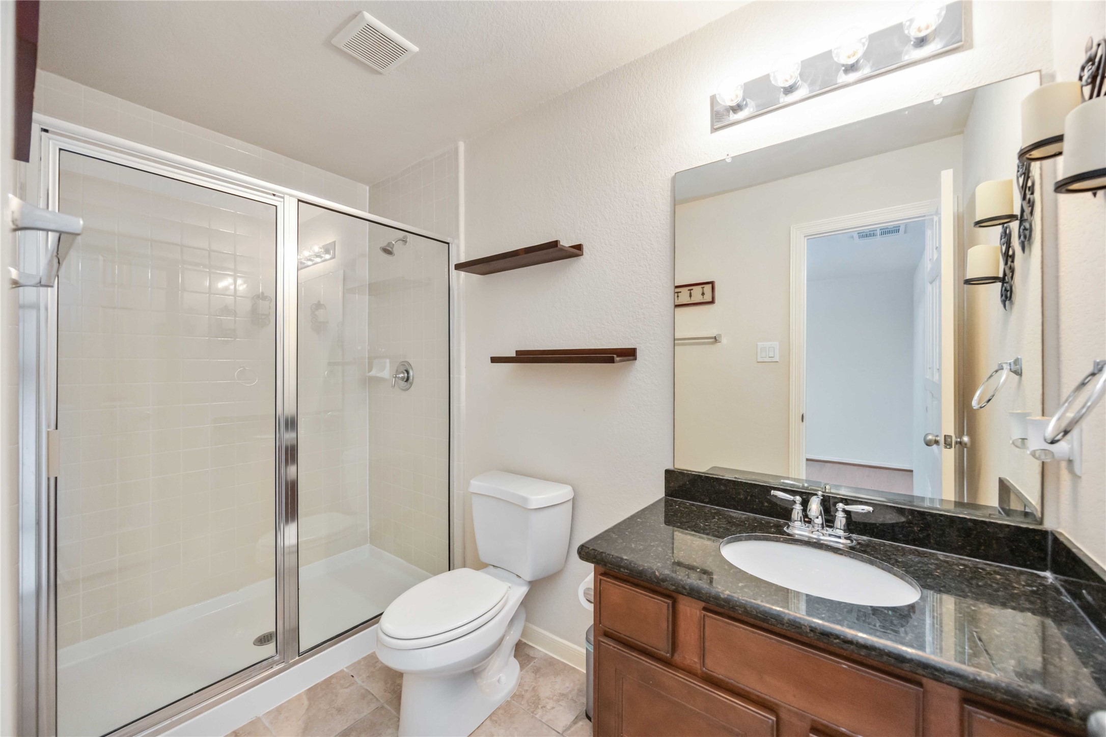3008 Clearview Circle Houston, TX 77025 - Photo 17 of 33 a bathroom with a granite countertop sink toilet and shower