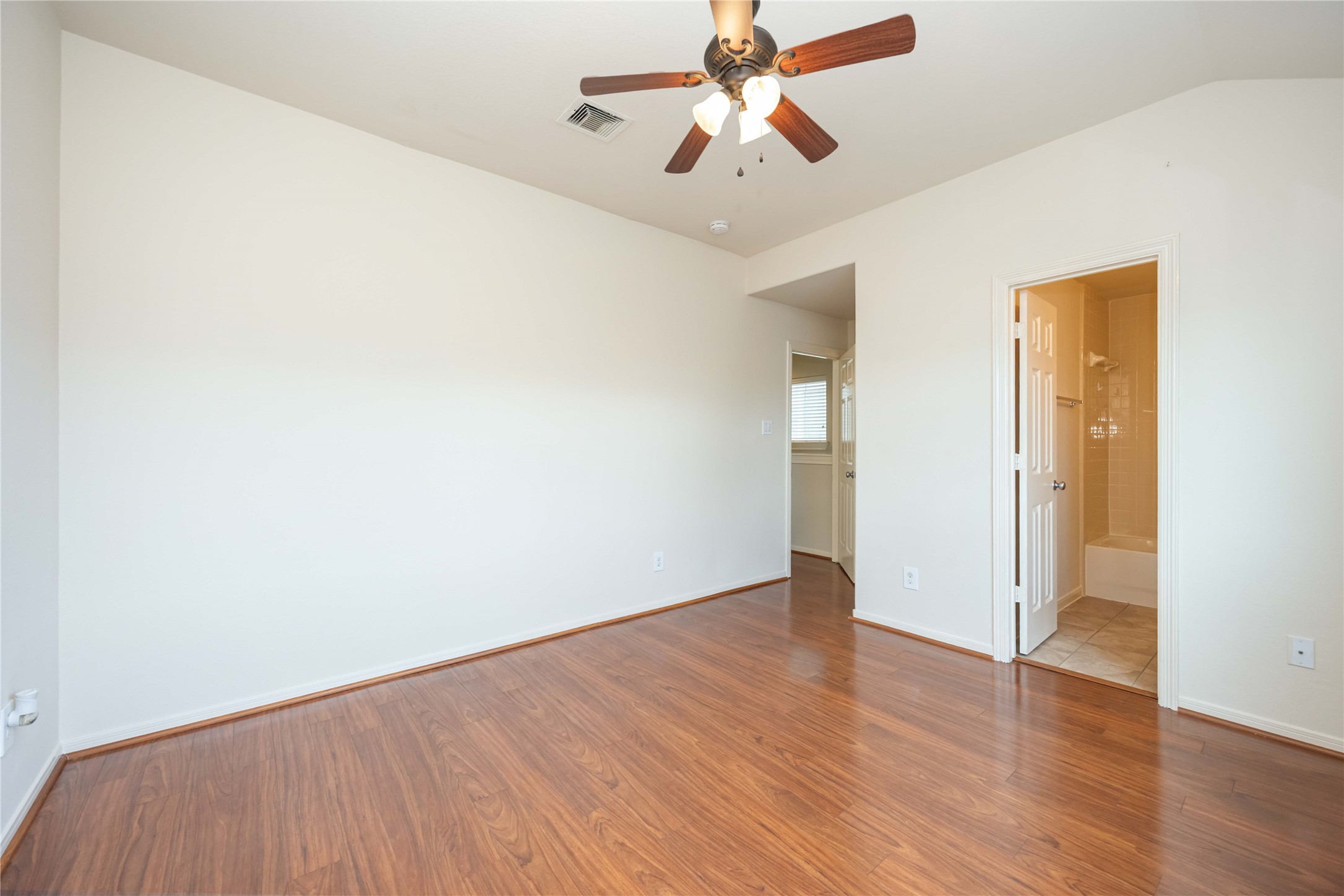 3008 Clearview Circle Houston, TX 77025 - Photo 29 of 33 an empty room with wooden floor fan and windows