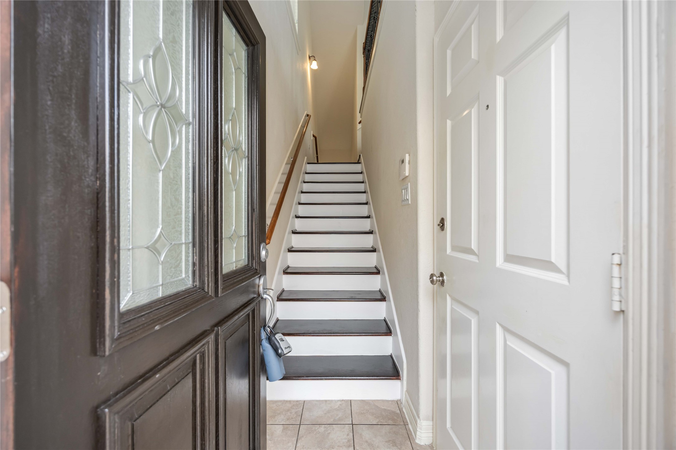 3008 Clearview Circle Houston, TX 77025 - Photo 4 of 33 a view of a hallway with wooden staircase and door