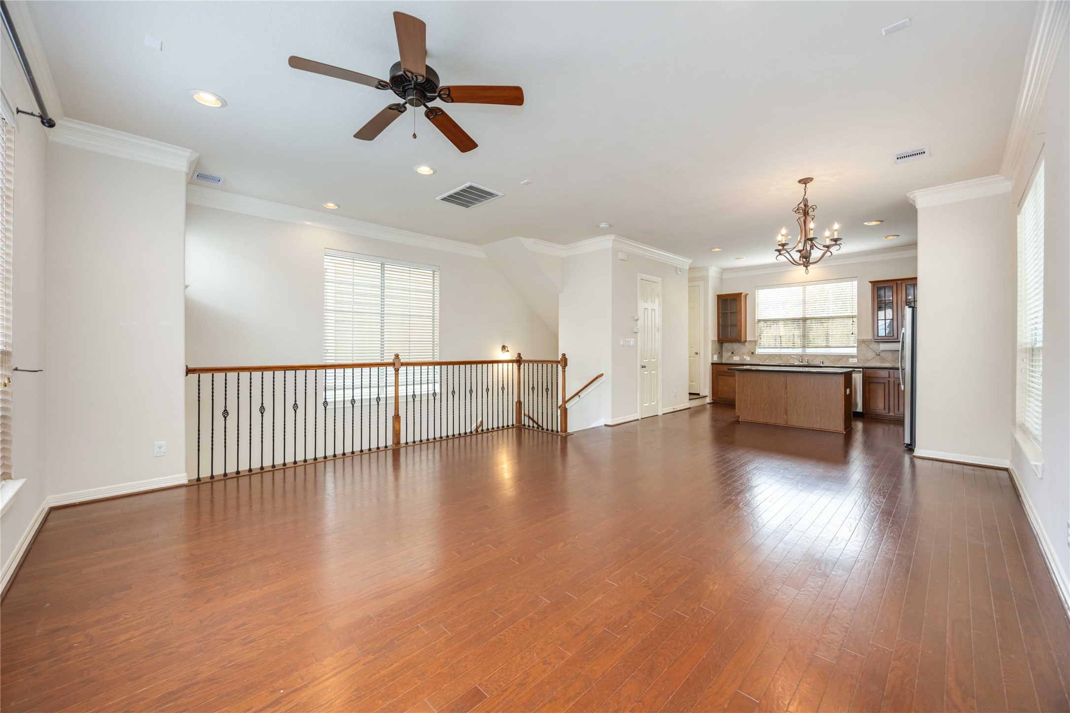 3008 Clearview Circle Houston, TX 77025 - Photo 7 of 33 an empty room with wooden floor fan and windows