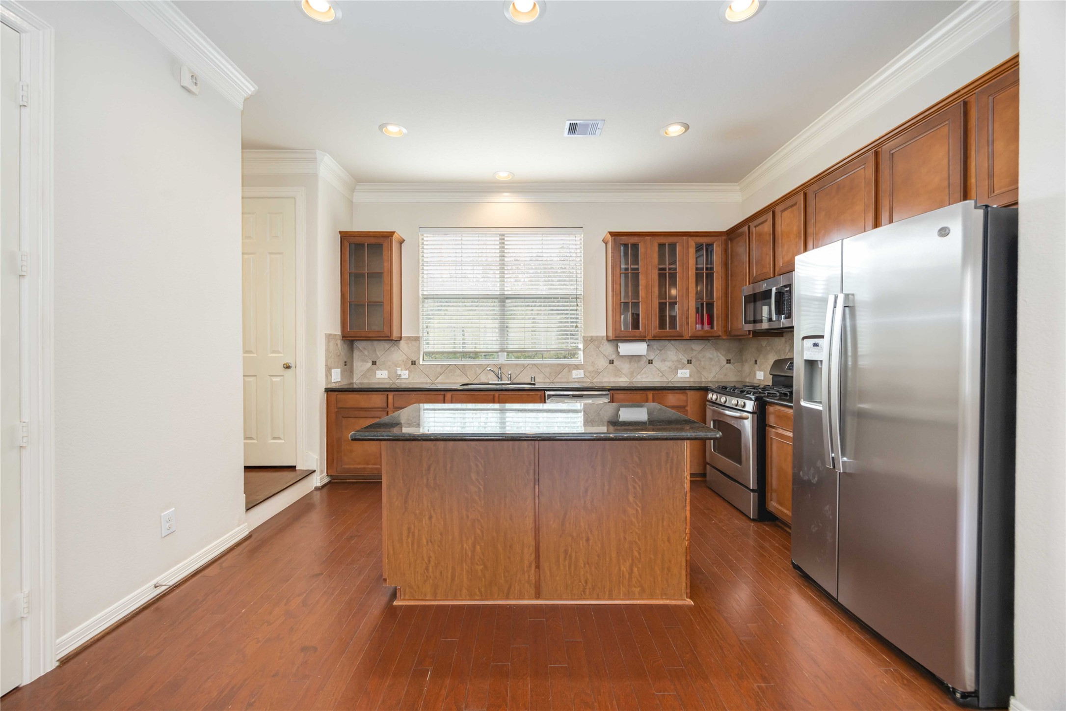 3008 Clearview Circle Houston, TX 77025 - Photo 10 of 33 a kitchen with granite countertop a refrigerator and a sink