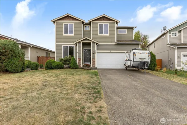 a front view of a house with a yard