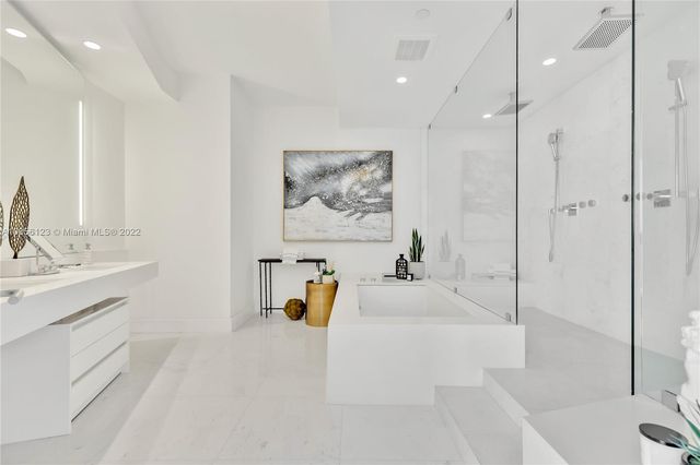 a living room with furniture a clock and a large window