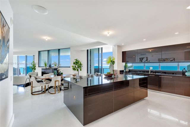 a living room with furniture a flat screen tv and a potted plant