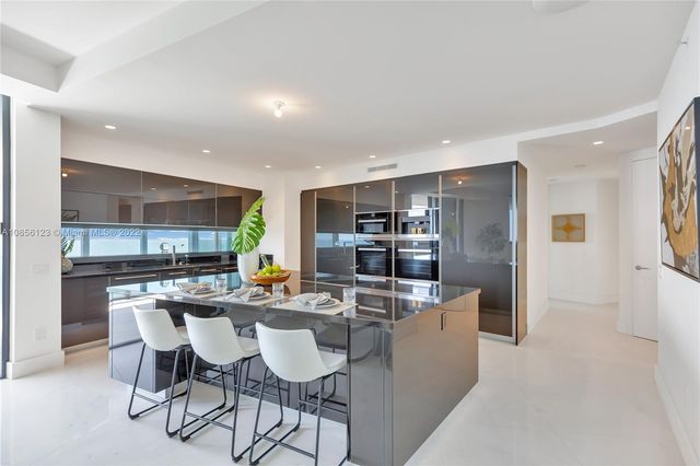 a living room with fireplace furniture and a potted plant