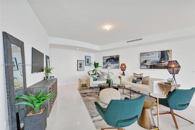a living room with furniture and a mirror