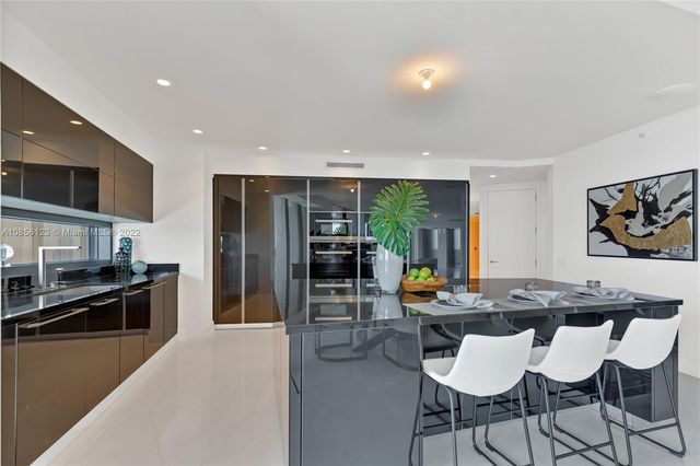 a living room with furniture large window and flat screen tv