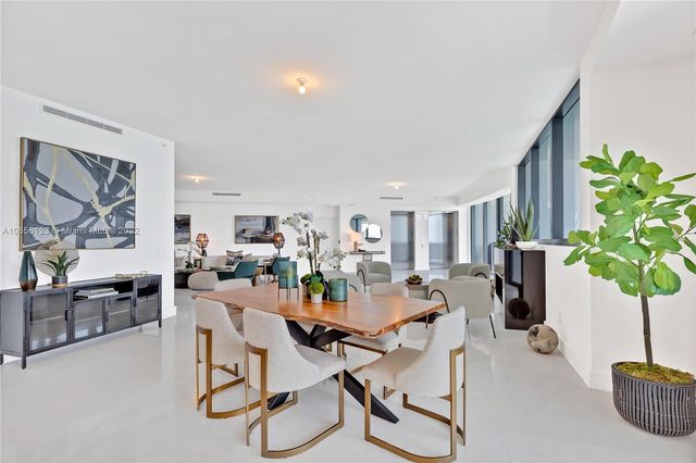 a living room with furniture and large window
