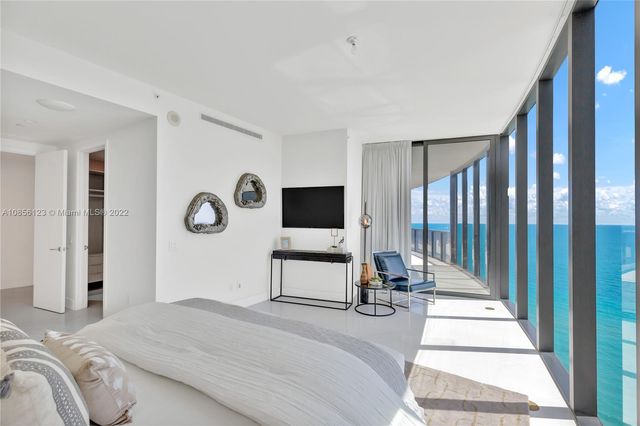 a spacious bathroom with a tub sink and mirror