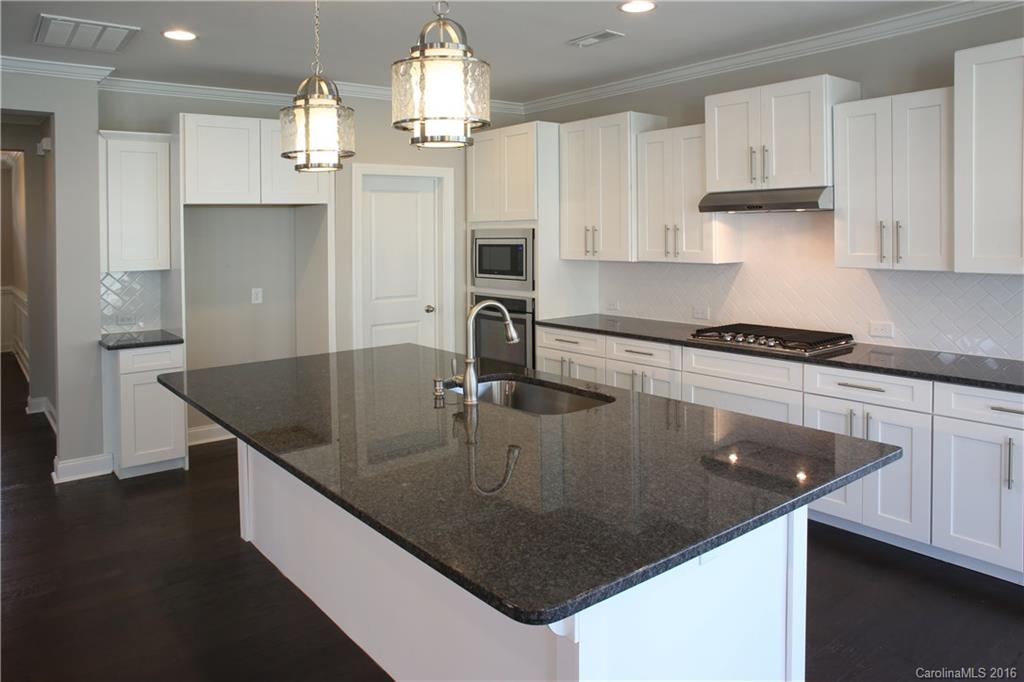 144 Helton Lane, Unit 35 Fort Mill, SC 29708 - Photo 3 of 18 a kitchen with stainless steel appliances granite countertop a sink a refrigerator and a stove
