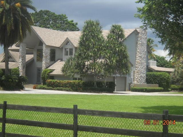 8601 Surrey Lane Boca Raton, FL 33496 - Photo 2 of 18 a front view of a house with a yard