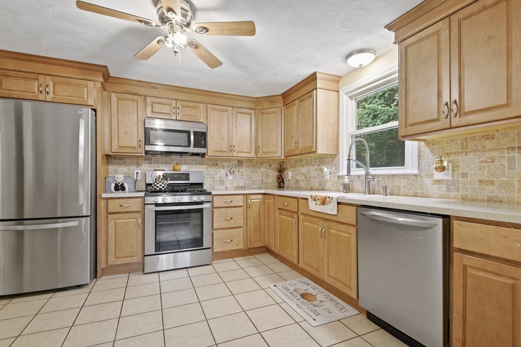 14 Porter Street Billerica, MA 01821 - Photo 12 of 33 a kitchen with a stove a sink and a refrigerator