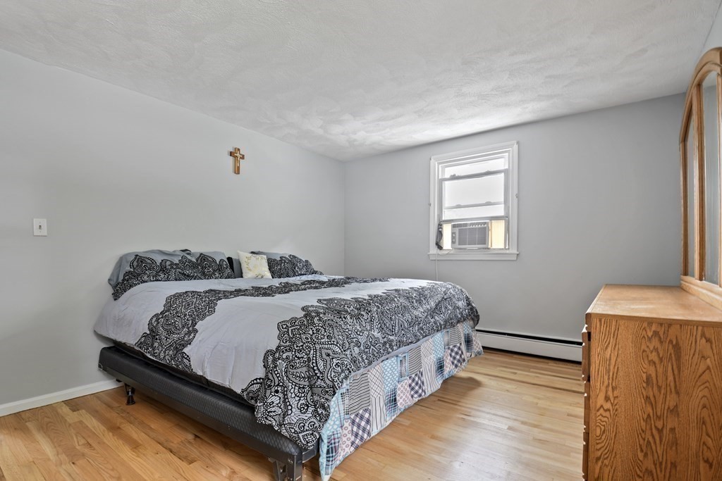 14 Porter Street Billerica, MA 01821 - Photo 18 of 33 a bedroom with a bed and wooden floor