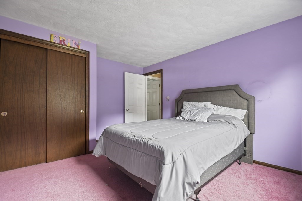 14 Porter Street Billerica, MA 01821 - Photo 22 of 33 a bedroom with a bed and a mirror