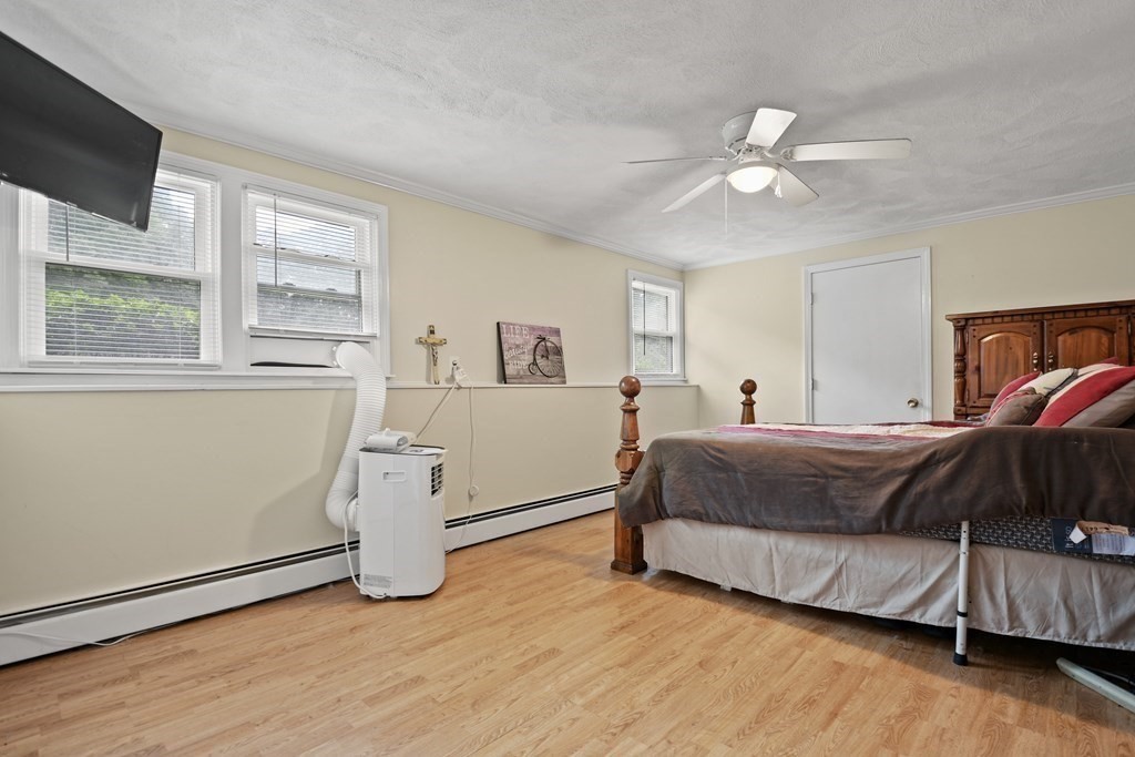 14 Porter Street Billerica, MA 01821 - Photo 23 of 33 a spacious bedroom with a bed and a window