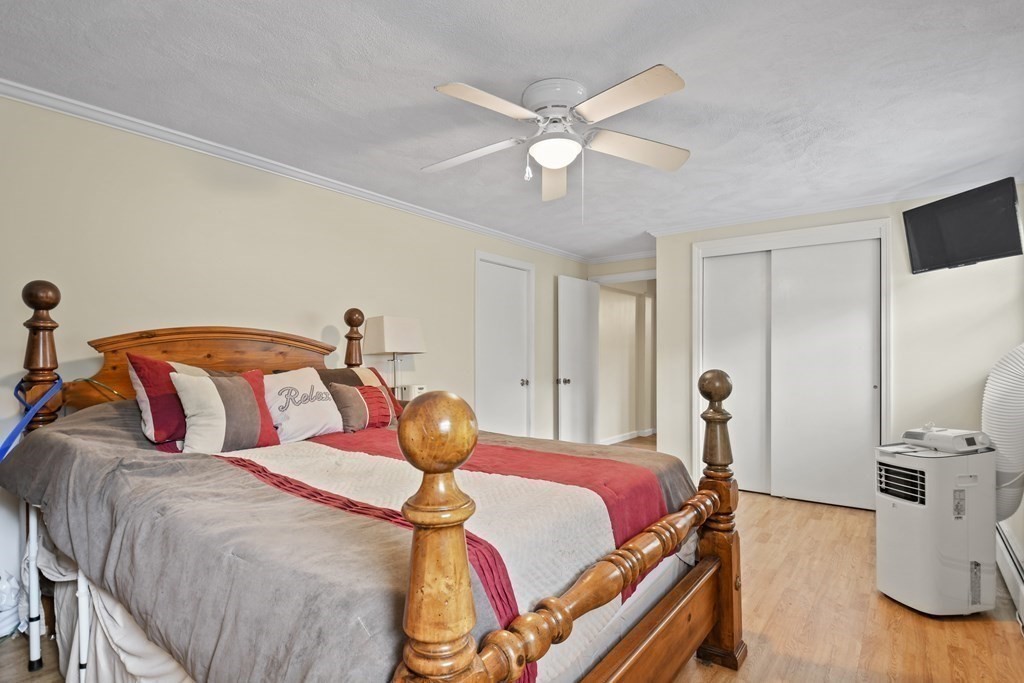 14 Porter Street Billerica, MA 01821 - Photo 24 of 33 a bedroom with a bed and wooden floor