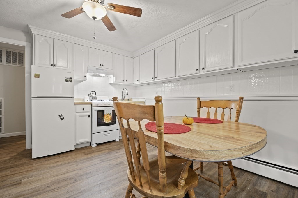 14 Porter Street Billerica, MA 01821 - Photo 26 of 33 a kitchen with stainless steel appliances kitchen island granite countertop a kitchen island a stove a table and chairs